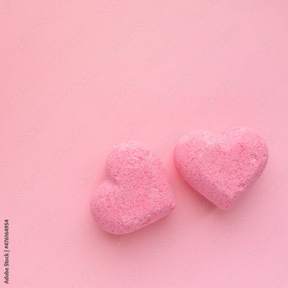 Bath bombs in the shape of heart on pink background, top view Bath bombs in the shape of heart on pink background, top view