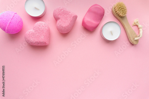 Fototapeta Naklejka Na Ścianę i Meble -  Valentine's day flat lay. Bath bombs, soap and candles on pink background, space for text