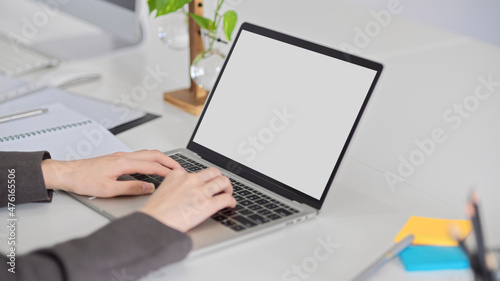 a businesswoman's hands typing on laptop computer