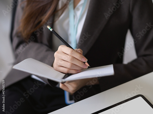 Business woman taking some notes on personal diary