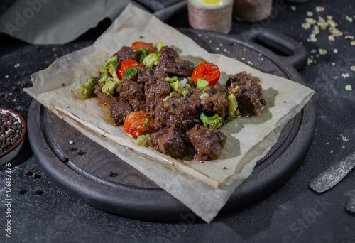 roast beef with vegetables on a wooden board