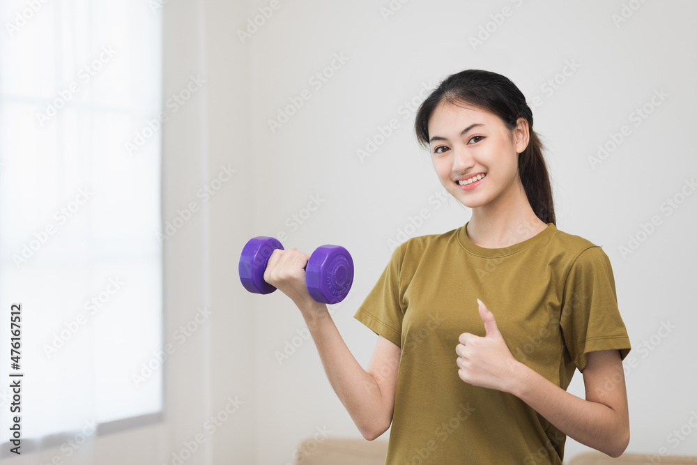Attractive asian young fitness woman lifting dumbbell weights workout at home in living room. Fresh feeling female training and exercise wearing sport wear fit body. Attractive asian young fitness woman lifting dumbbell weights workout at home in living room. Fresh feeling female training and exercise wearing sport wear fit body.
