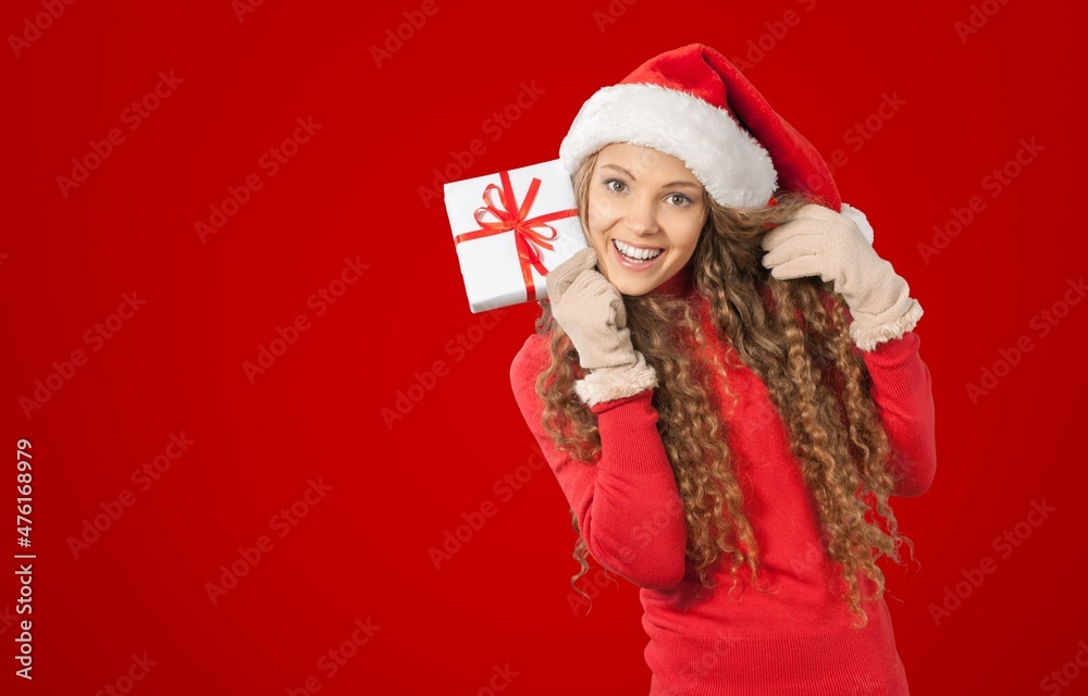 Portrait of attractive cheerful girl showing blank space on red color background Portrait of attractive cheerful girl showing blank space on red color background