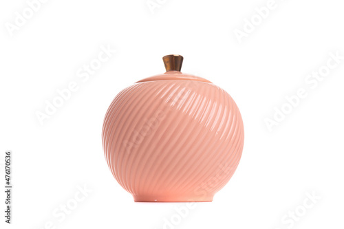 textured peach colored porcelain sugar bowl on white background