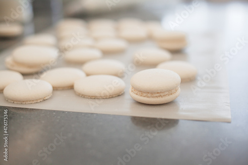 close-up of woman makes macaroons and puts it in the oven baked