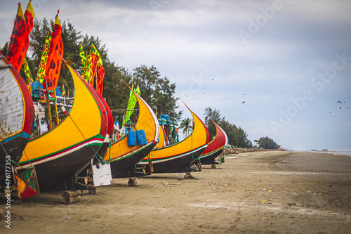 Fishing Boats docked on the beach in Cox's Bazar, Bangladesh photo