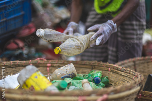 Waste collectors sorting through trash in Teknaf, Bangladesh photo