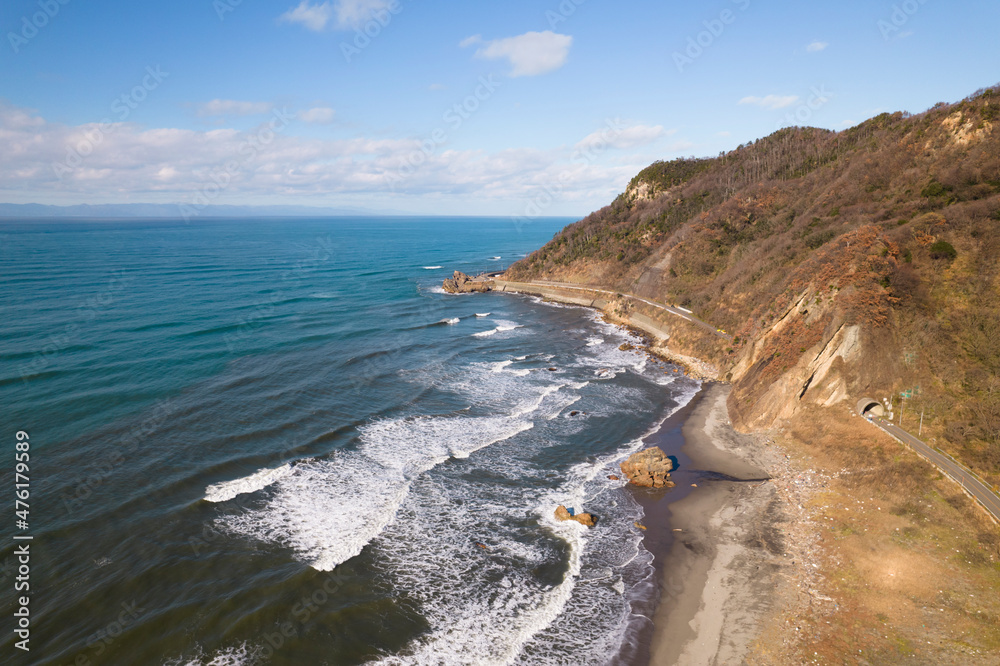 冬の日本海の岬の海岸にうち寄せる波　ドローン空撮　俯瞰撮影