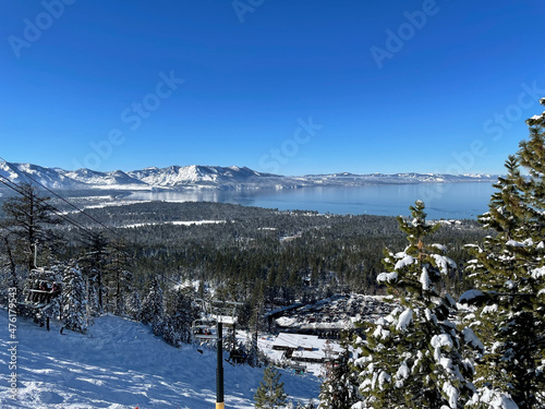 Landscape view of Lake Tahoe framed by trees from a ski resort on a bluebird winter day