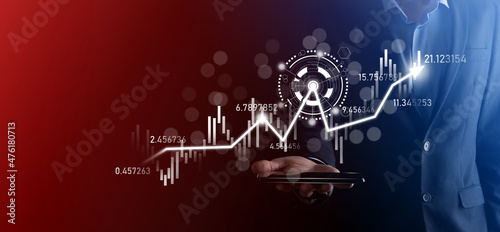 Businessman in hand hold banking business finance graph and invest in stock market investment point,economic growth and investor concept.analysis virtual stock market chart,analyze by use technology