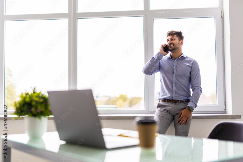 Business man working on computer at office calling on phone. Business man working on computer at office calling on phone.