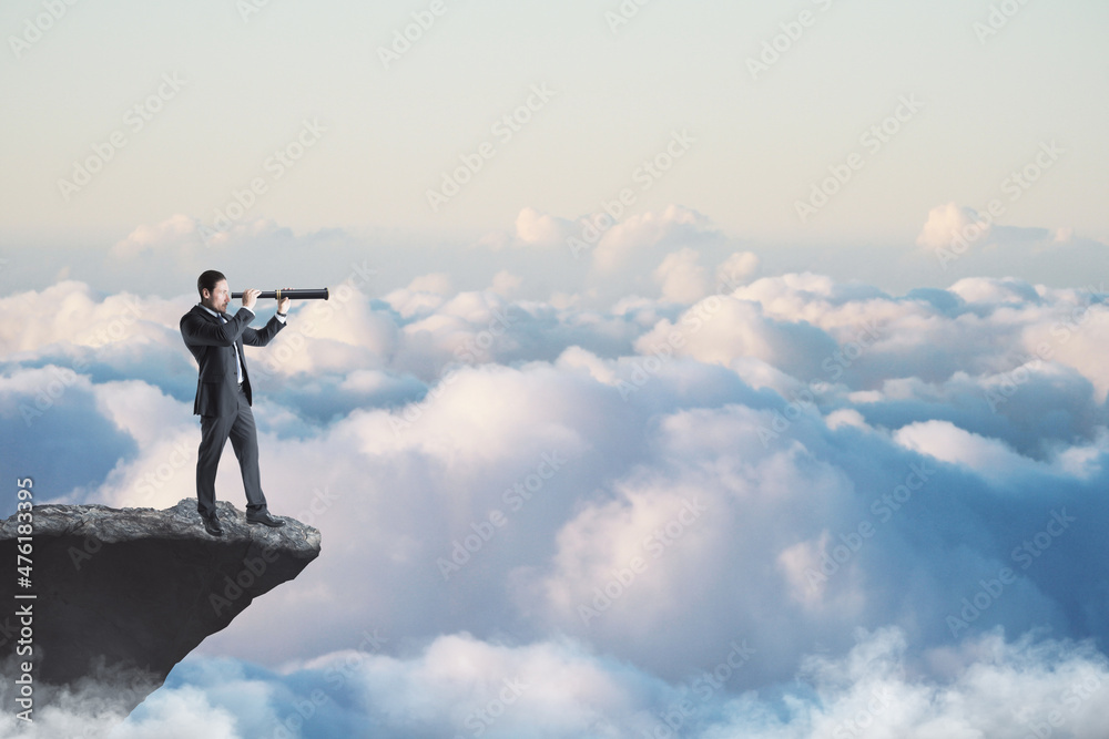 Abstract image of businessman with telescope looking into the distance while standing on edge of cliff, mock up place on sky with clouds background. Success, challenge, future and growth concept.