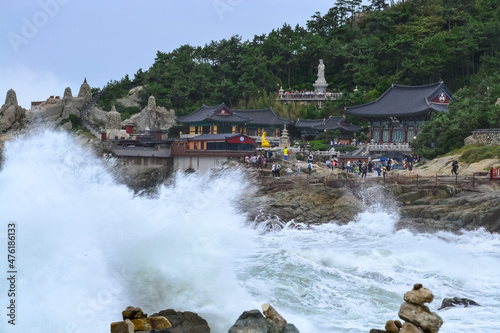 Splashes of water breaking on rocks in front of the Haedong Yonggungsa Temple in Busan. photo