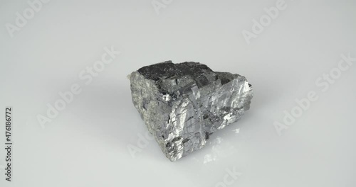 Rotation galena mineral on a white background. Lead ore. photo