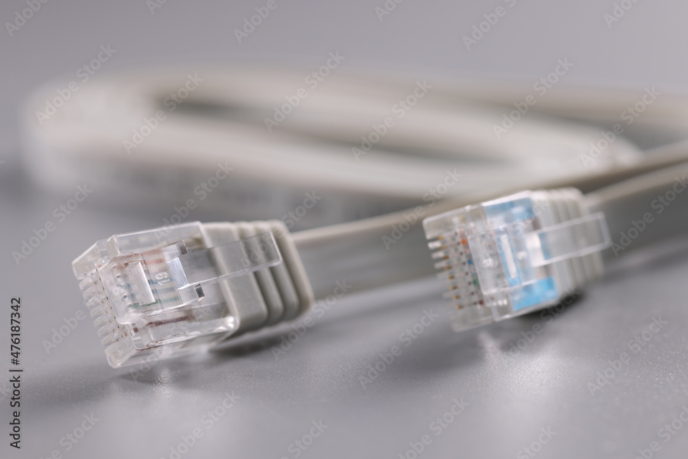 Pair of internet connectors on grey background, cable with plastic clip Pair of internet connectors on grey background, cable with plastic clip