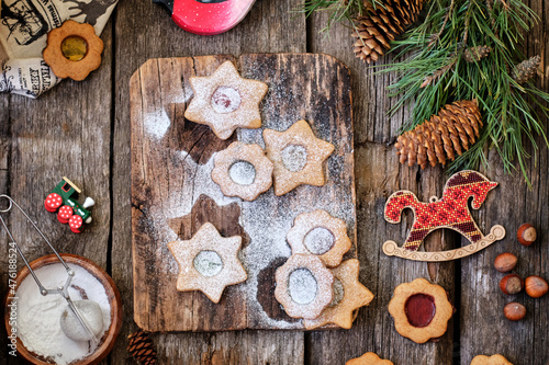christmas linzer cookies with spices ion a wooden board