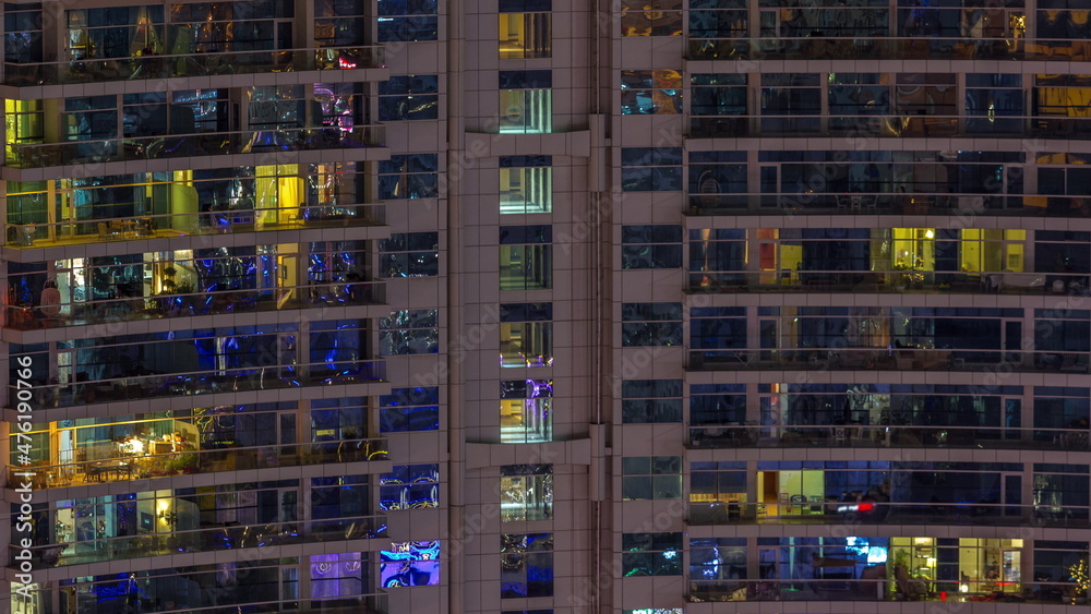 Night view of exterior apartment colorful building timelapse with windows