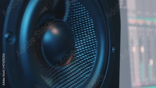 Close-up shooting. The movement of the membrane of the speaker of the studio audio monitor. The diffuser makes forward and backward movements. Thanks to this, sound is produced.