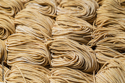  Dried egg noodles in wooden blocks isolated on white background.