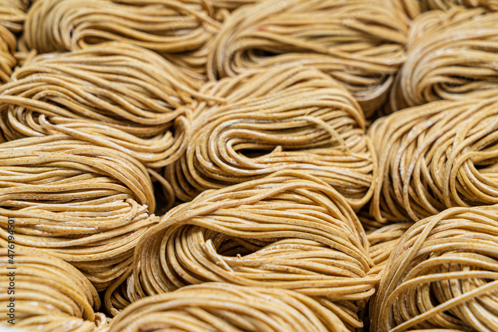 Dried egg noodles in wooden blocks isolated on white background. Dried egg noodles in wooden blocks isolated on white background.