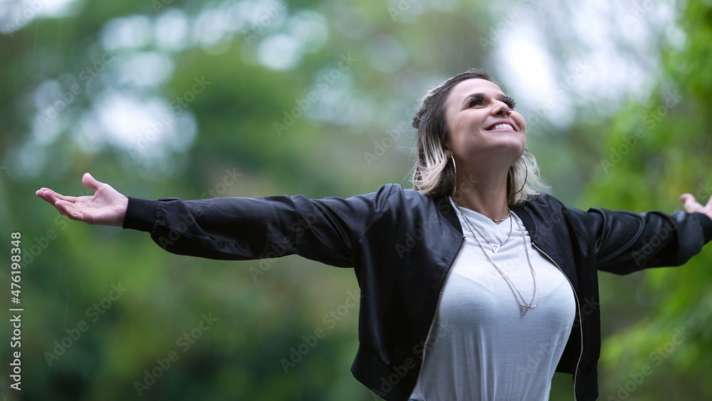 Young woman feeling the rain outside spinning Young woman feeling the rain outside spinning