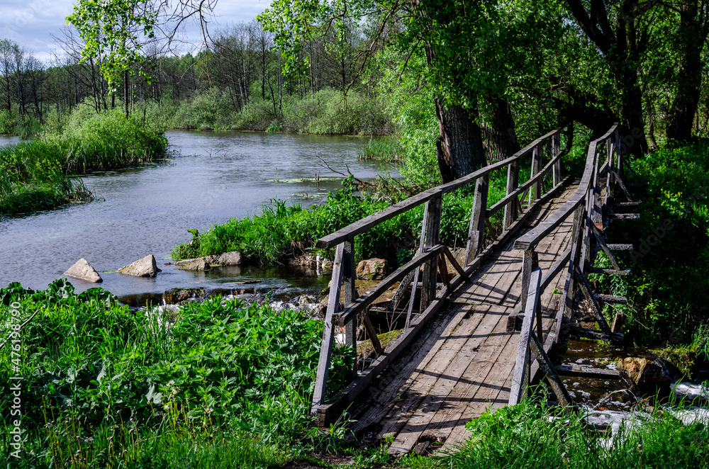 Wooden bridge over the Titva river near the village of Yartsevo. Bridge to the other side Wooden bridge over the Titva river near the village of Yartsevo. Bridge to the other side