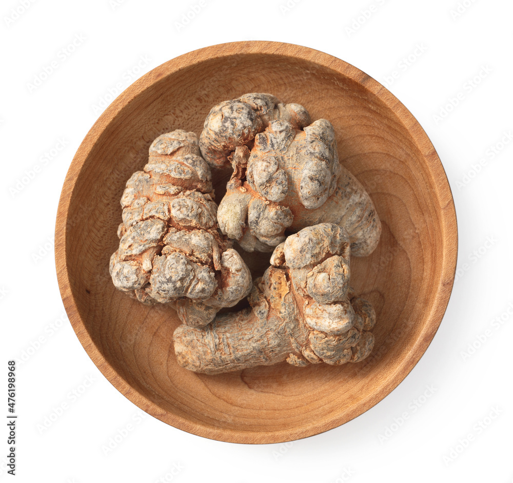 Dried notoginseng in the wooden bowl, isolated on white background, top view Dried notoginseng in the wooden bowl, isolated on white background, top view