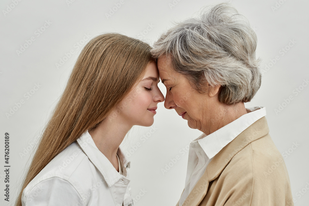 Profile of happy granddaughter and senior woman Profile of happy granddaughter and senior woman