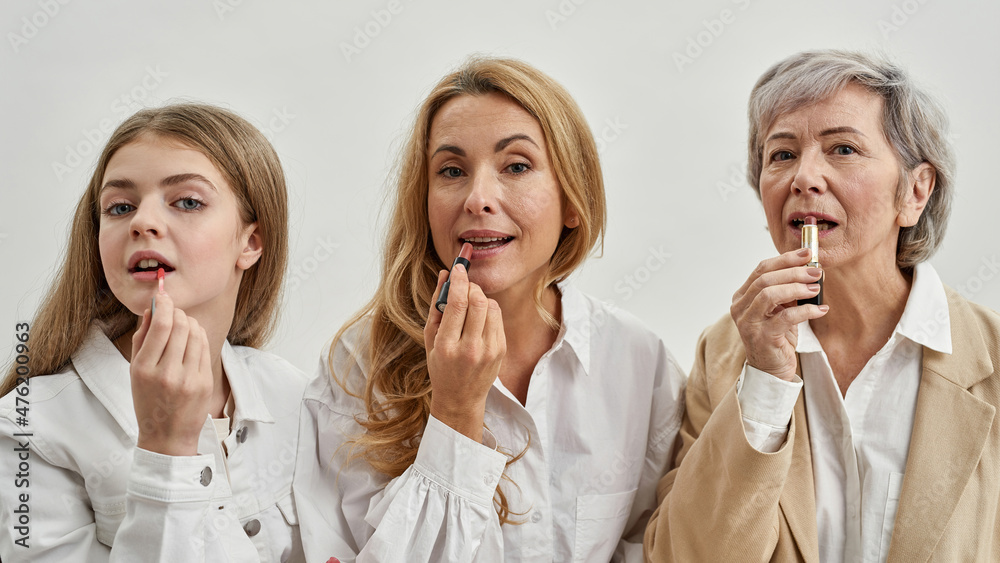 Females painting lips of herself with lipsticks Females painting lips of herself with lipsticks