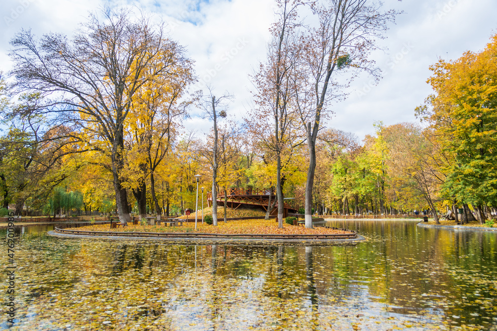 The lake from the Roman park in the autumn surrounded by colored trees, Romania The lake from the Roman park in the autumn surrounded by colored trees, Romania