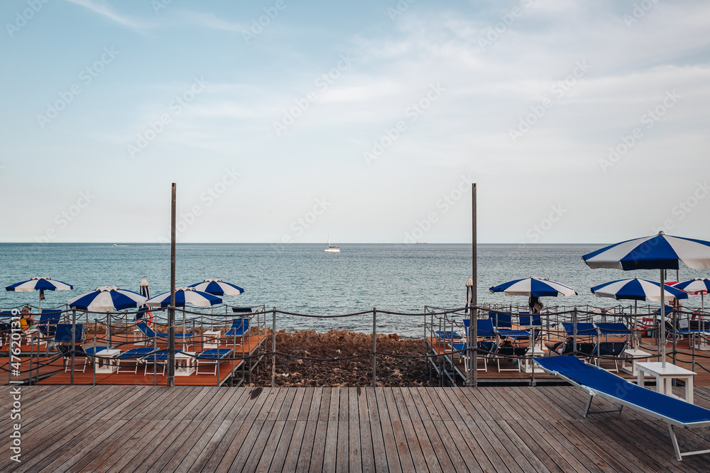 Naklejka premium Santa Maria di Leuca, Italy-June 2021: deck chairs on the beautiful coastiline in the southern part of Puglia