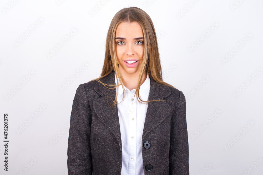 Young business woman wearing jacket over white background with nice beaming smile pleased expression. Positive emotions concept Young business woman wearing jacket over white background with nice beaming smile pleased expression. Positive emotions concept