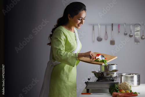 Young woman cooking vegetable in the kitchen photo