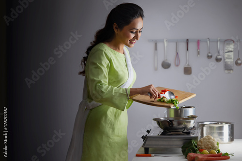 Young woman cooking vegetable in the kitchen