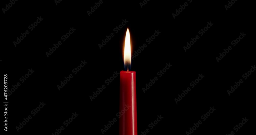 Candle on a black background. The flame of the candle slowly flickers. One candle slowly flickers. Ideal for background or over-layer with blending mode add, screen, lighten. Candle on a black background. The flame of the candle slowly flickers. One candle slowly flickers. Ideal for background or over-layer with blending mode add, screen, lighten.