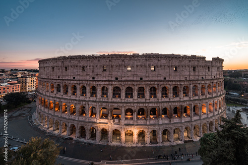 Panoramic image of Colosseum (Coliseum) in Rome, Italy, at sunrise and sunset. 