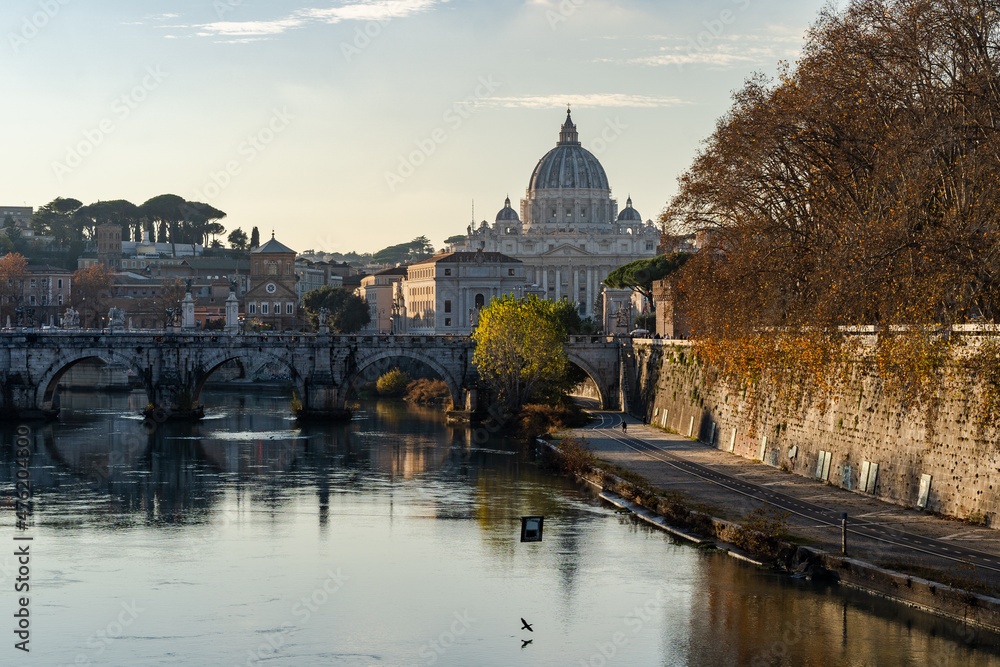 Rome, Italy. Vatican dome of Saint Peter Basilica (Italian: San Pietro) and Sant'Angelo Bridge, over Tiber river.
