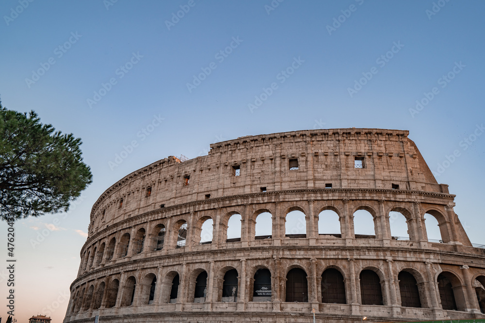 Panoramic image of Colosseum (Coliseum) in Rome, Italy, at sunrise and sunset. 
