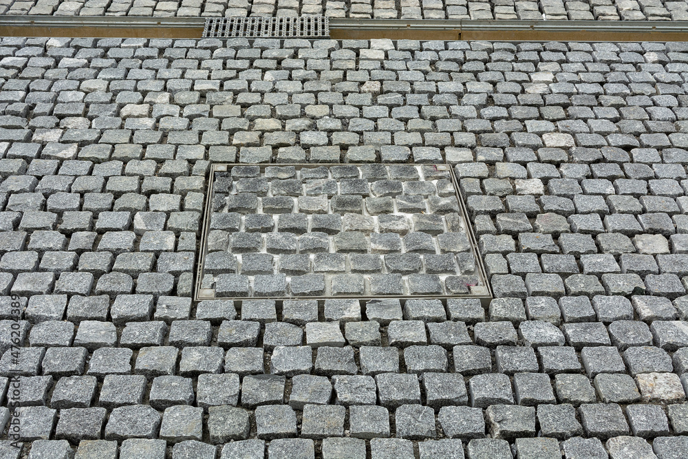 rectangular quarried stone used in paving streets, visible gaps, stormwater drainage channel rectangular quarried stone used in paving streets, visible gaps, stormwater drainage channel