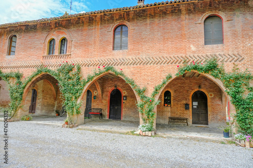 Grazzano-Visconti medieval building with three arches covered with plants. Italy, Piacenza, Emilia-Romagna © Kate