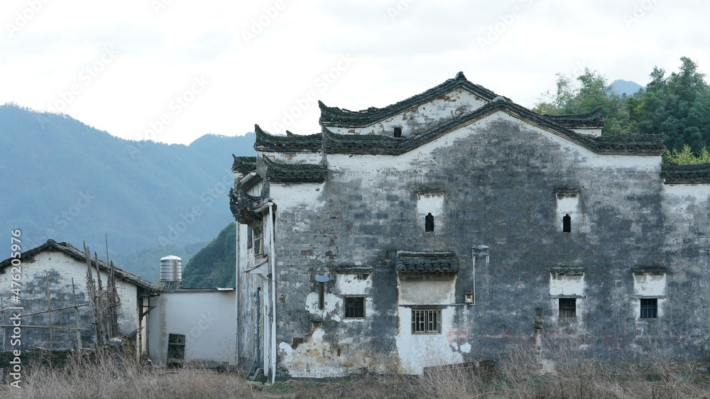 The beautiful and old traditional Chinese village view with the mountains around it located in the countryside of the southern China The beautiful and old traditional Chinese village view with the mountains around it located in the countryside of the southern China