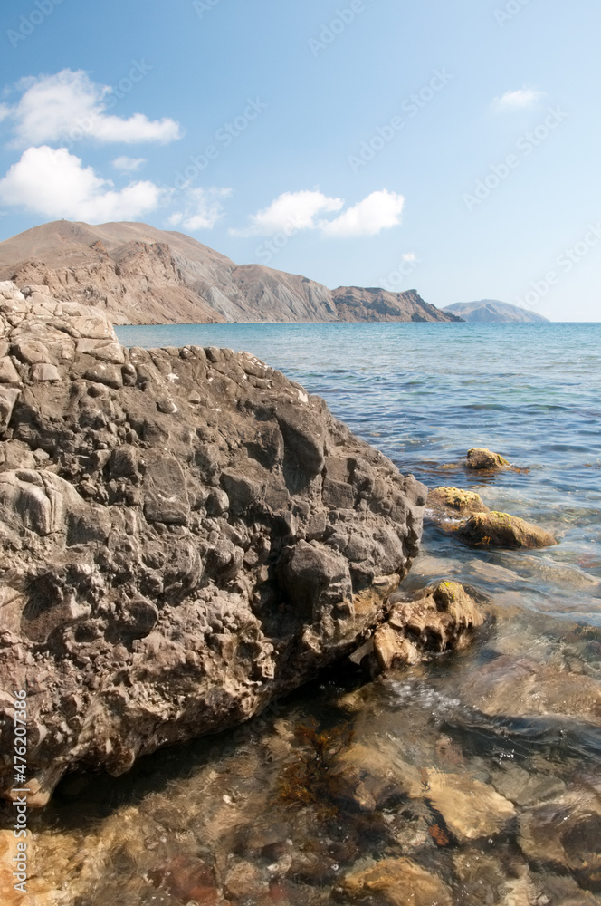 Black Sea coast in Crimea with rocky beach in the foreground, Koktebel village, Russian Federation Black Sea coast in Crimea with rocky beach in the foreground, Koktebel village, Russian Federation