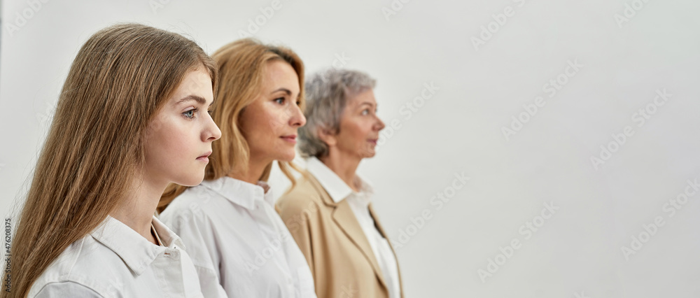 Family of three femaless astand and look away Family of three femaless astand and look away