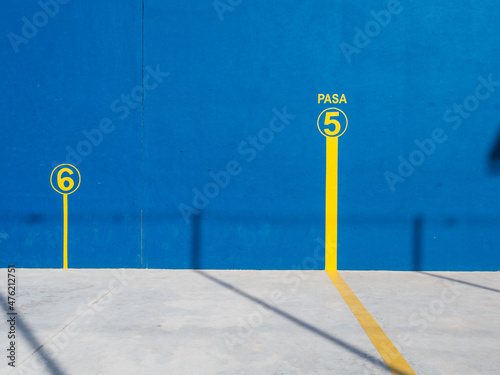 Cement blue walls of the wall of a pediment for outdoor sport with yellow line photo
