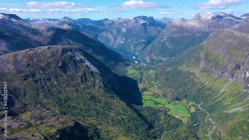 Breath taking view of mountain peaks and green valley and a lake in geiranger fjord in Norway Breath taking view of mountain peaks and green valley and a lake in geiranger fjord in Norway