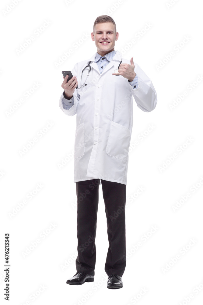 in full growth. young doctor with a smartphone. in full growth. young doctor with a smartphone.