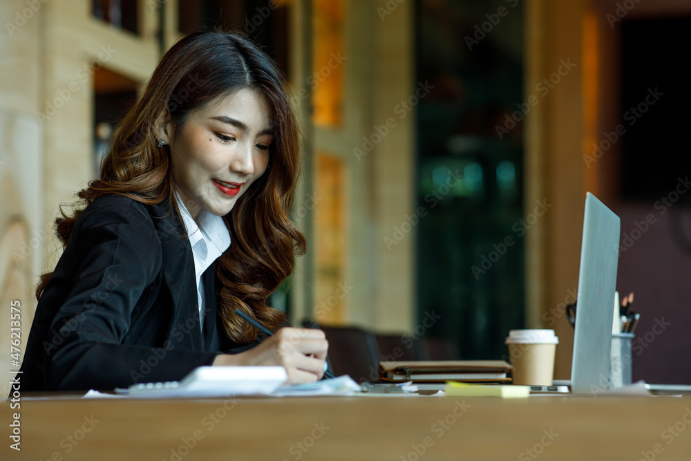 Young adult businesswoman at his office, doing planning analyzing the financial report, business plan investment, finance analysis concept