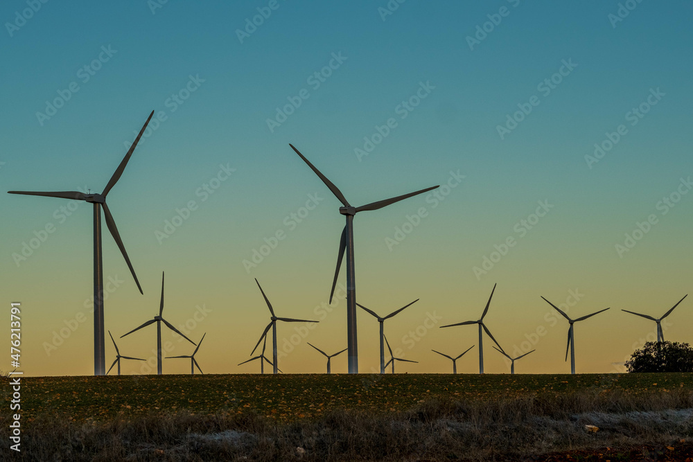 Windmills at dawn at the Cuesta Colorada wind farm in Tébar. LaMancha, Spain. Windmills at dawn at the Cuesta Colorada wind farm in Tébar. LaMancha, Spain.