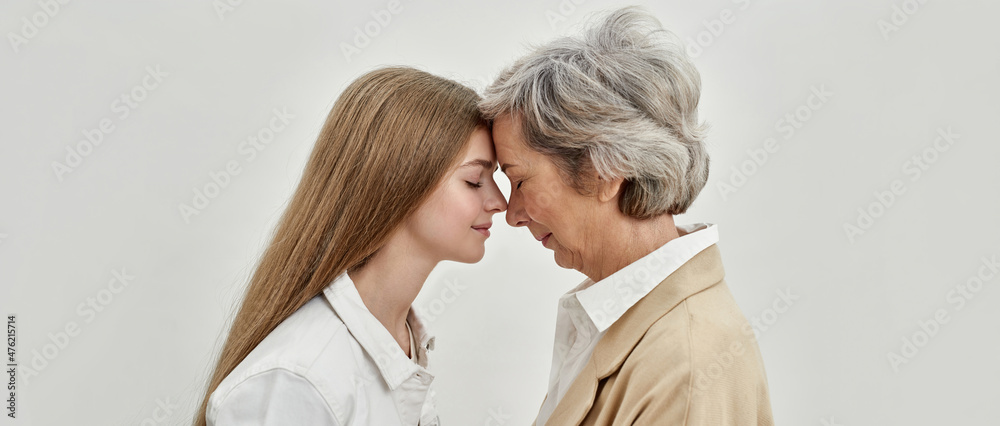 Face to face of caucasian girl and senior woman Face to face of caucasian girl and senior woman