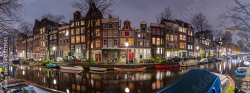 Panorama of the city waterfront of Amsterdam at sunset. © pillerss